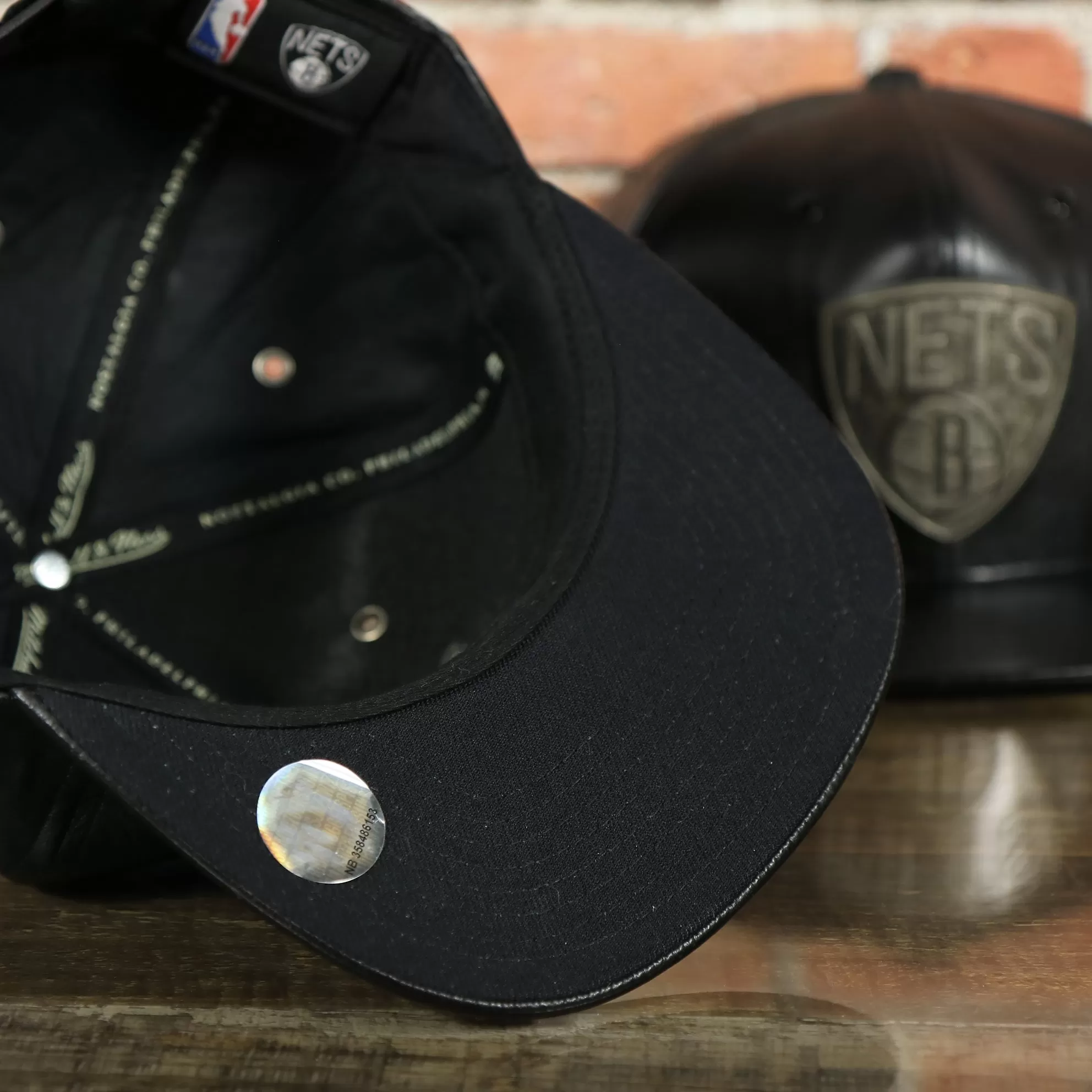 Brooklyn Nets 100% Genuine Lambskin Leather Mitchell and Ness Embossed Metalic Shield Snapback Hat